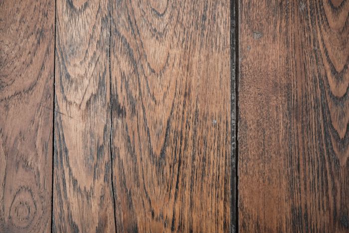 Close detail of stained old-growth wood floor grain.